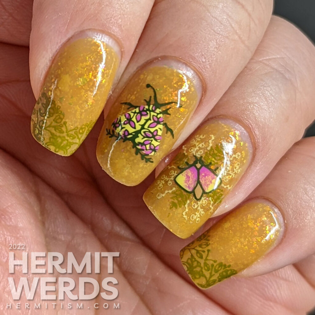 A mustard yellow nail art with whimsical floral patterns and moth stamping images. A ManixMe Springtime Stroll mani.