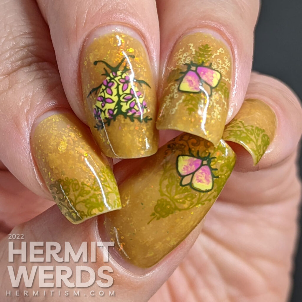 A mustard yellow nail art with whimsical floral patterns and moth stamping images. A ManixMe Springtime Stroll mani.