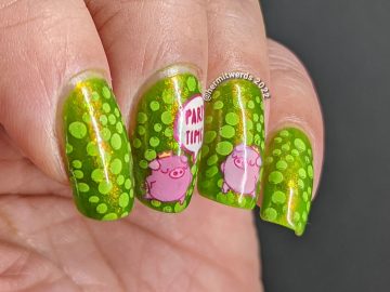 A polka dot pig nail art with party pig reverse stamping decals and polka dots tucked between layers of a bright green jelly polish.
