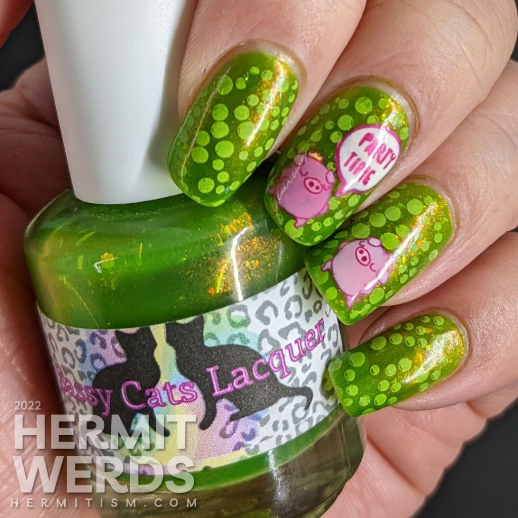 A polka dot pig nail art with party pig reverse stamping decals and polka dots tucked between layers of a bright green jelly polish.