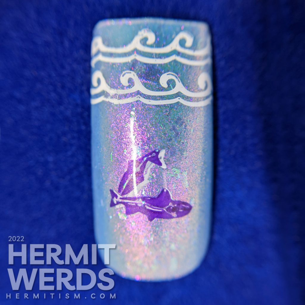 Baby blue Pisces nail art with two large purple and silver fish stamping decals marked with the Pisces sign and wave french tip stampings.