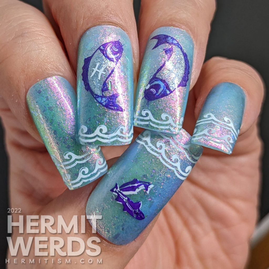 Baby blue Pisces nail art with two large purple and silver fish stamping decals marked with the Pisces sign and wave french tip stampings.
