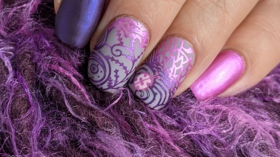 Ladybug nail art with magenta and purple metallic stamping polishes in magically wild patterns.
