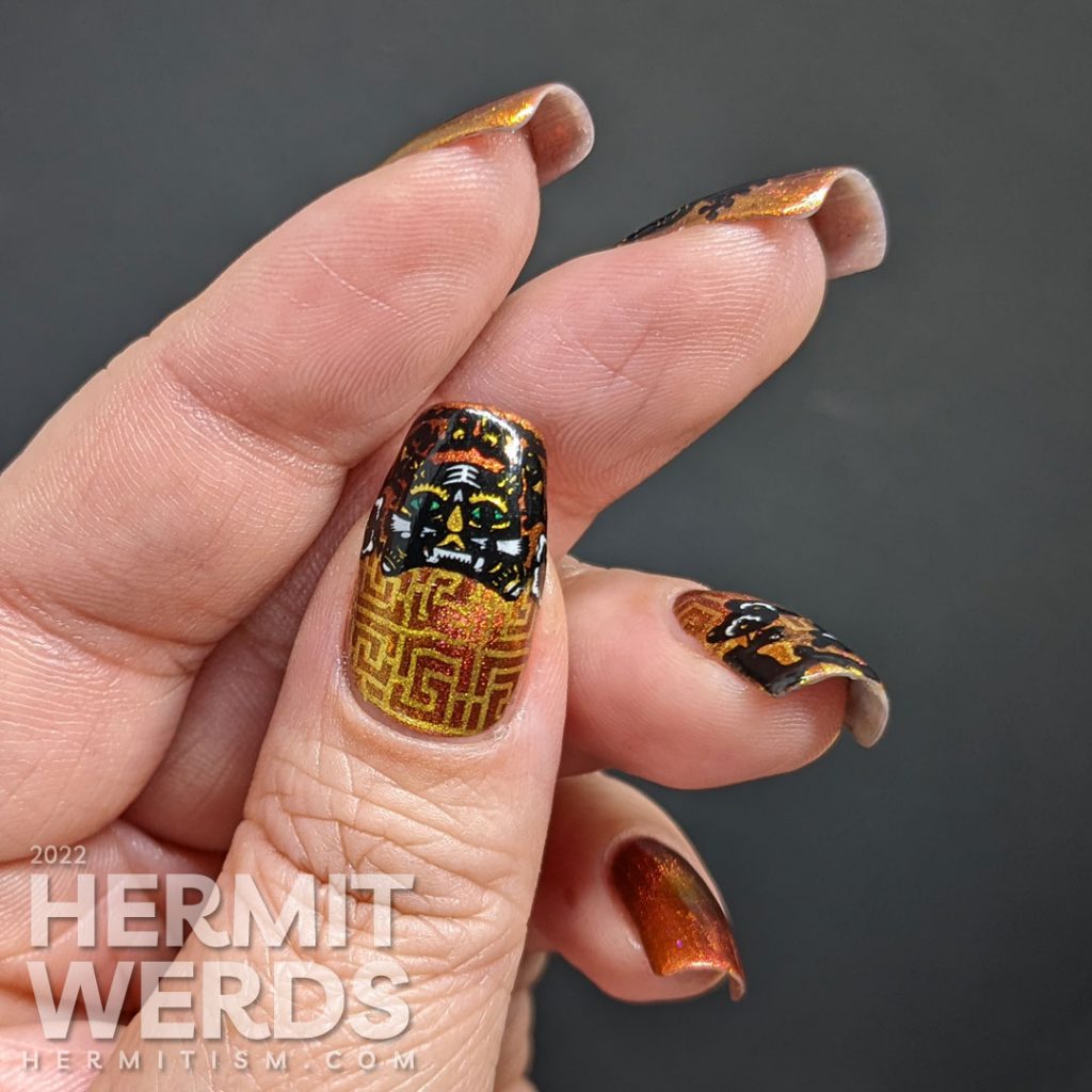 A lovely red, pink, and gold multichrome magnetic nail polish paired with tiger paper cut stamping images for a Year of the Tiger zodiac mani.