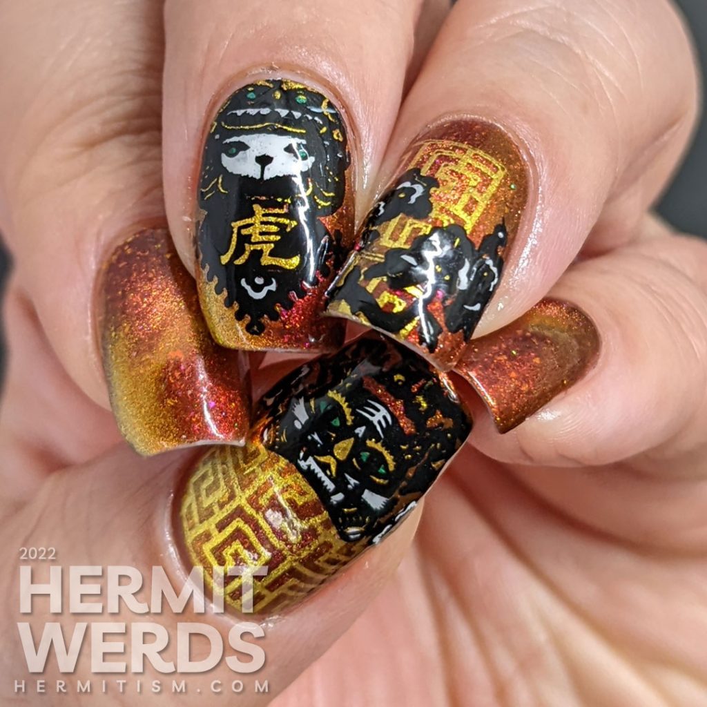 A lovely red, pink, and gold multichrome magnetic nail polish paired with tiger paper cut stamping images for a Year of the Tiger zodiac mani.