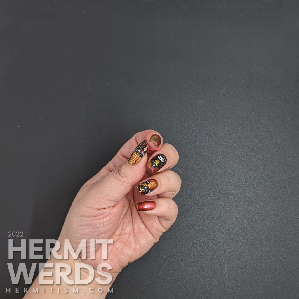A lovely red, pink, and gold multichrome magnetic nail polish paired with tiger paper cut stamping images for a Year of the Tiger zodiac mani.