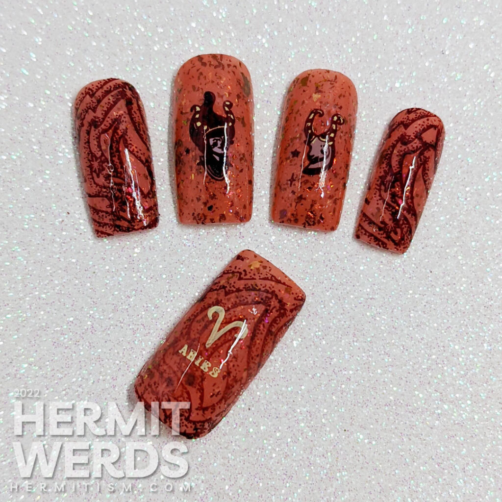 A fiery brick rose crelly nail art with red zodiac stamping images of stylized goat and girl with horn and the symbol for Aries.