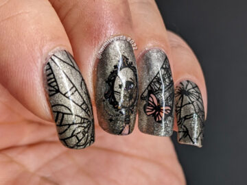 A silver magnetic bad luck nail art with reverse stamping decals of broken mirrors, mirror shards, and butterflies.