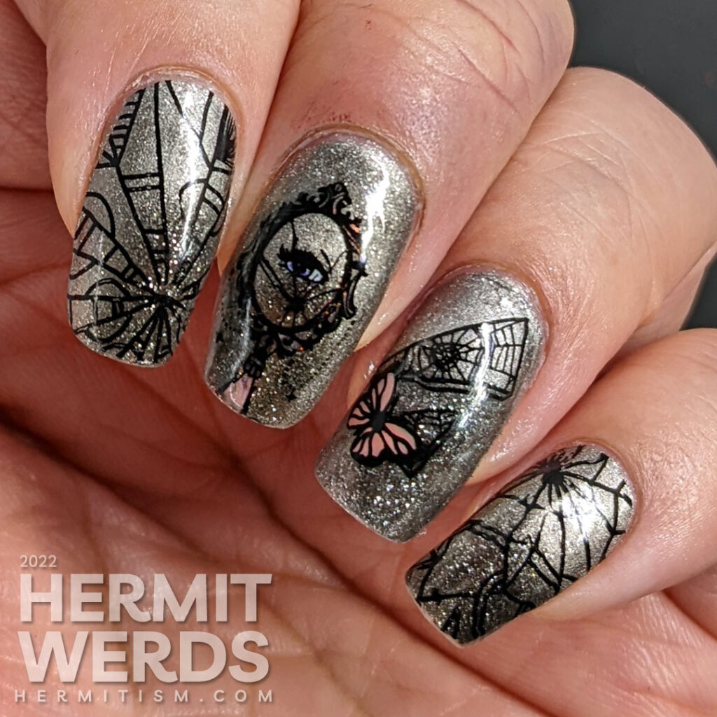 A silver magnetic bad luck nail art with reverse stamping decals of broken mirrors, mirror shards, and butterflies.