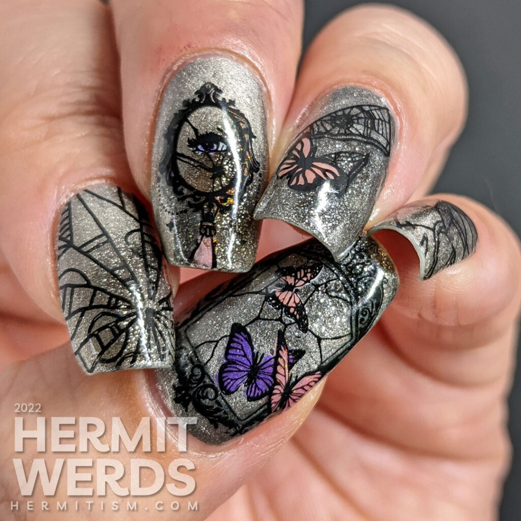 A silver magnetic bad luck nail art with reverse stamping decals of broken mirrors, mirror shards, and butterflies.