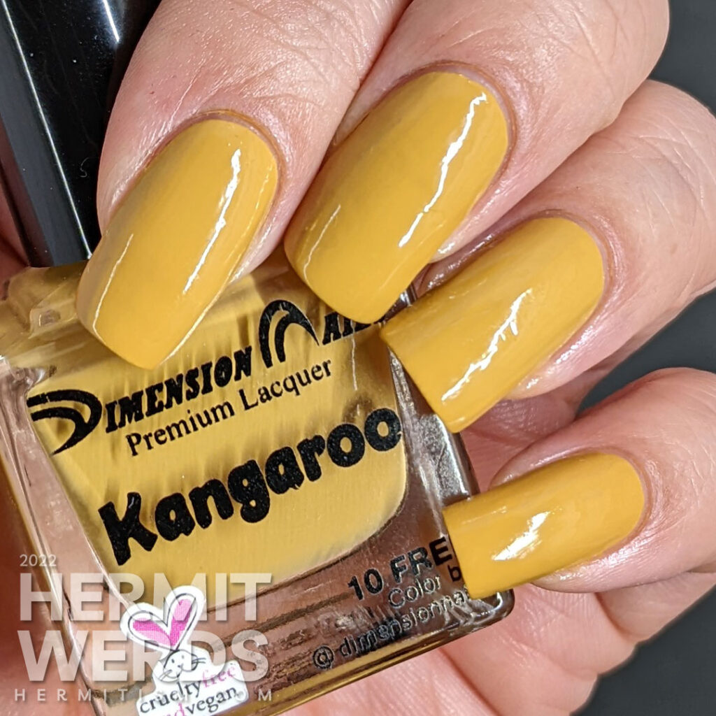 A nail swatch of Dimension Nails "Kangaroo", a smooth tan/yellow/mustard creme indie polish.
