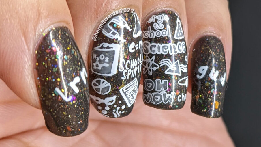 Back to school nail art with chalkboard stamping images about education topics (esp science) on a charcoal rainbow flakie background.
