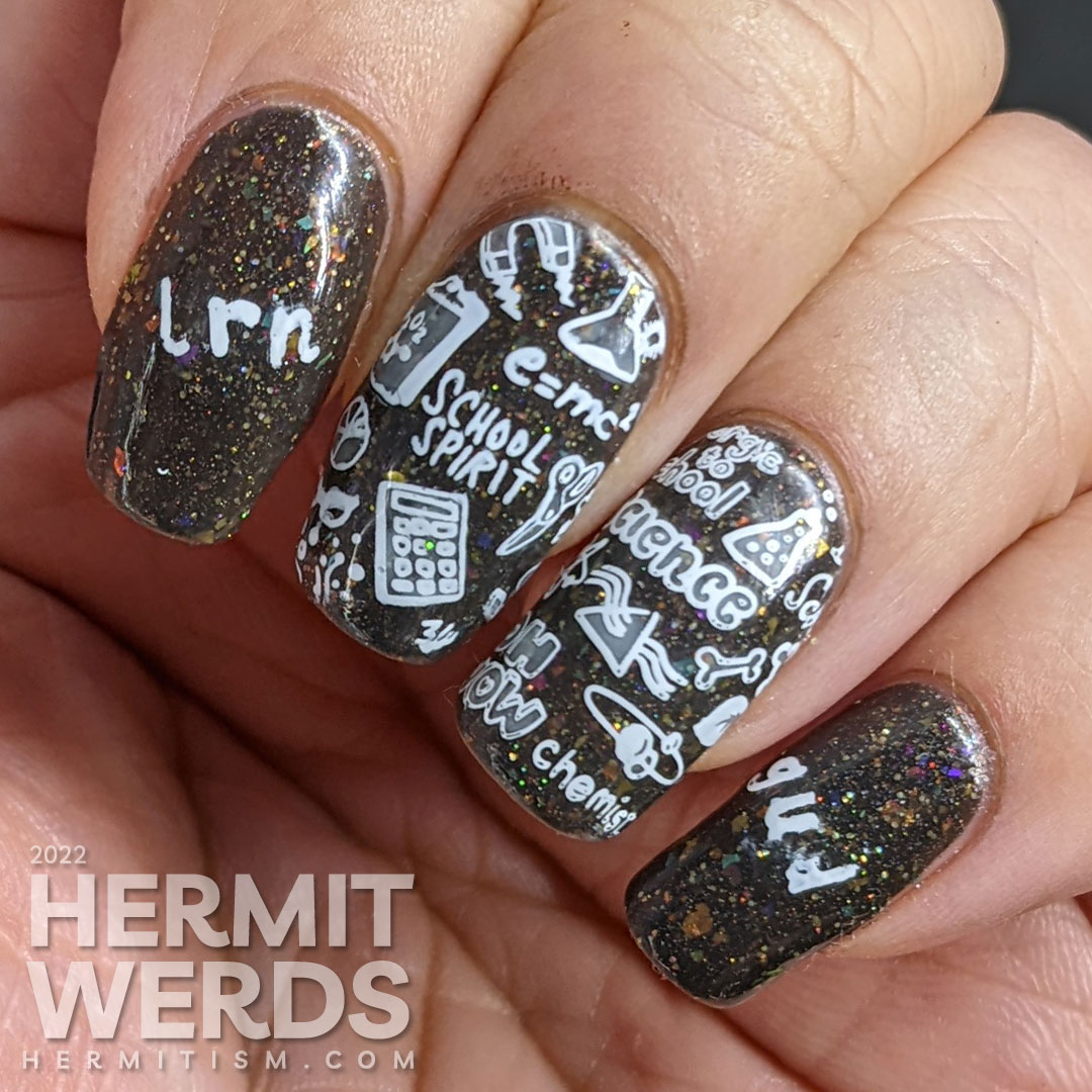 Back to school nail art with chalkboard stamping images about education topics (esp science) on a charcoal rainbow flakie background.