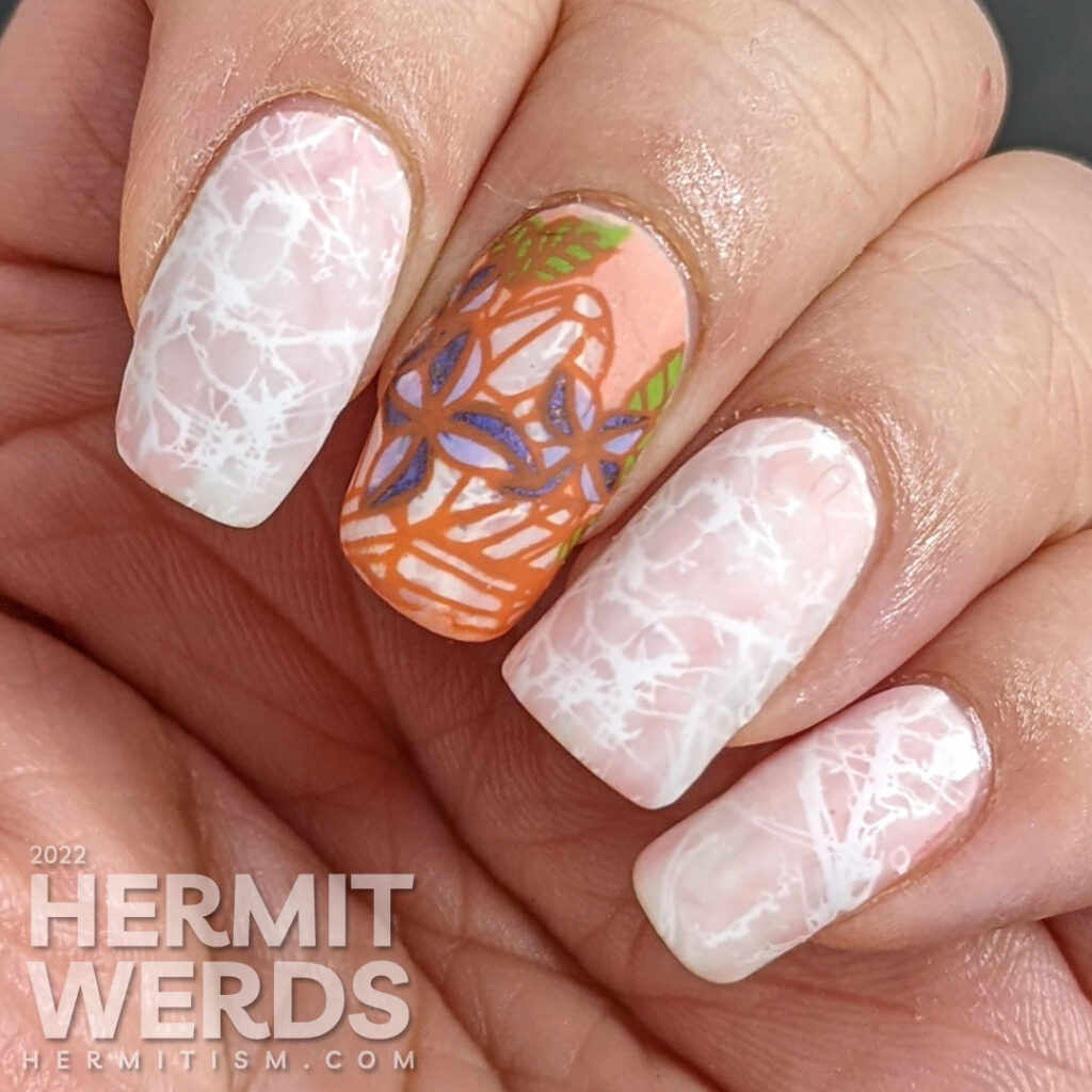 Quartz crystal nail art in soft corals and whites with a reverse stamping images of quartz crystals with purple spring flowers.