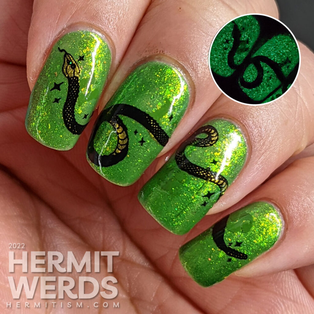 A green glow in the dark nail art with a long snake stamping decal stretched across the nails and a hidden snake-y message.