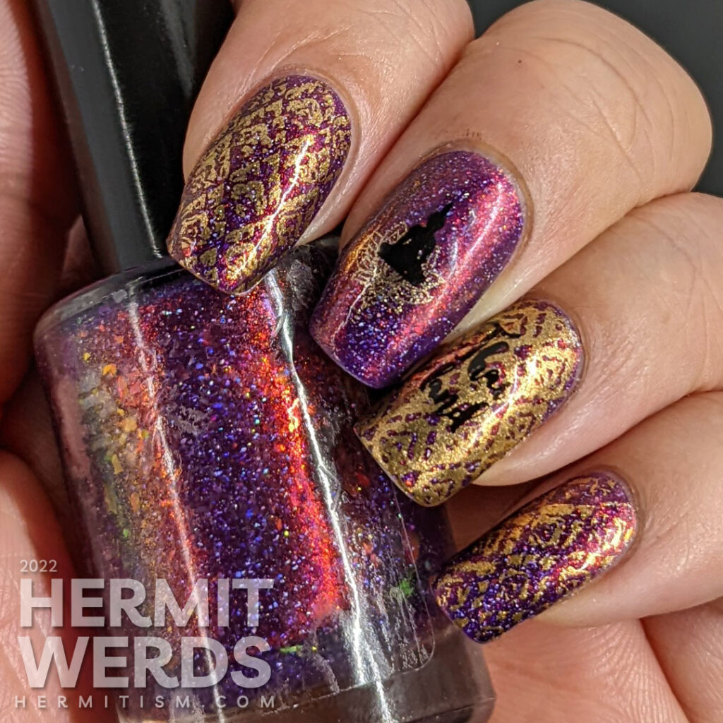 A brocade-like Thailand nail art featuring Buddah meditating over a lotus blossom + a Thai flame fabric pattern over a flakie purple polish.