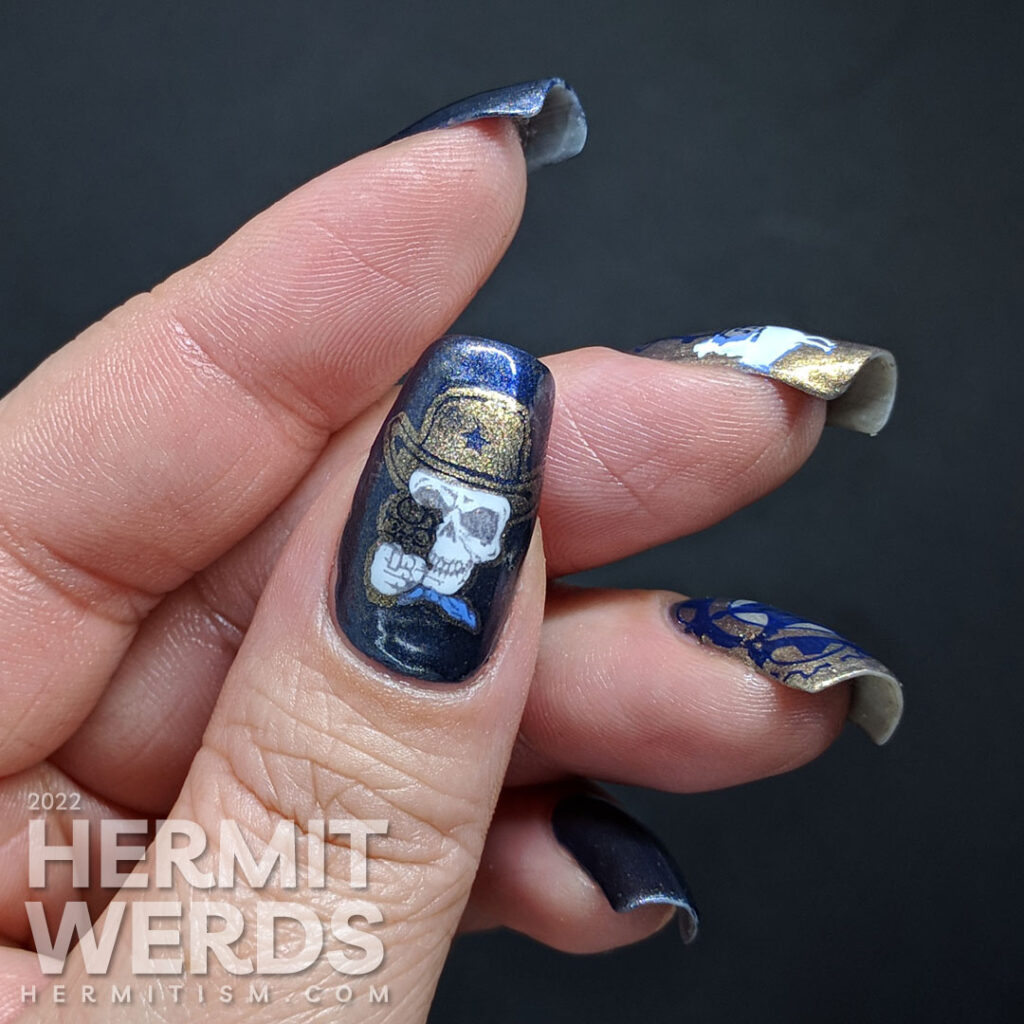 A dark blue steampunk nail art with a Westernpunk theme of sheriffs and horses stamped with an old gold stamping polish.