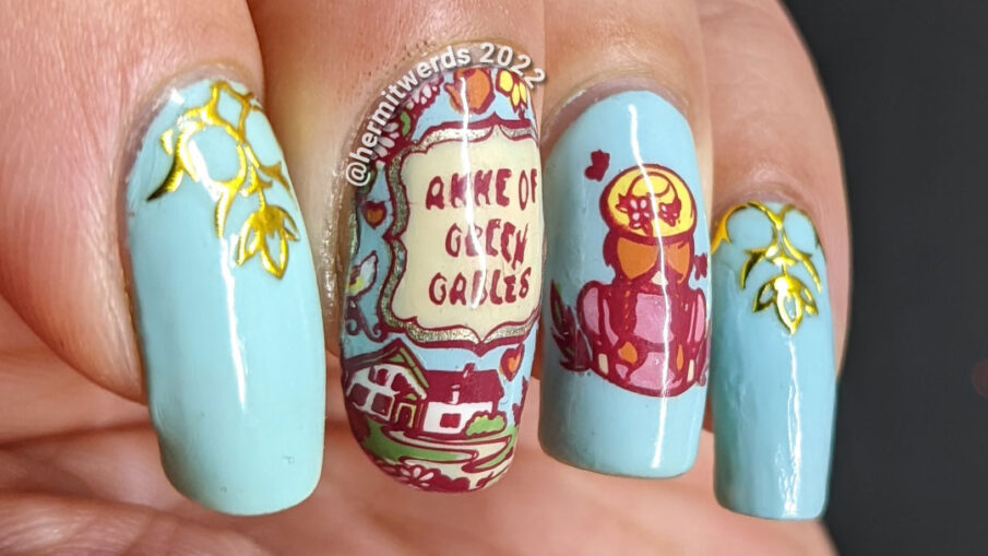 A book/tv/movie inspired Anne of Green Gables mani with stamping decals of the book cover and Anne with gold decorative nail stickers.