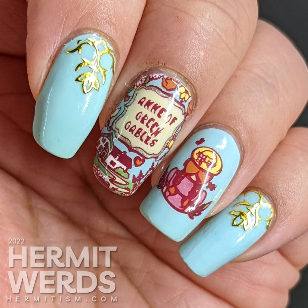 A book/tv/movie inspired Anne of Green Gables mani with stamping decals of the book cover and Anne with gold decorative nail stickers.
