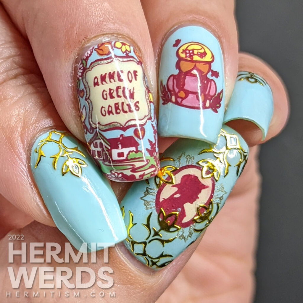 A book/tv/movie inspired Anne of Green Gables mani with stamping decals of the book cover and Anne with gold decorative nail stickers.