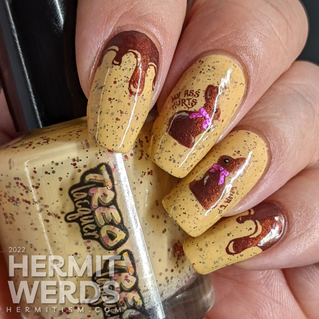 A mustard crelly with small purple and red glitters with chocolate Easter bunny stamping decals who have been munched on top.