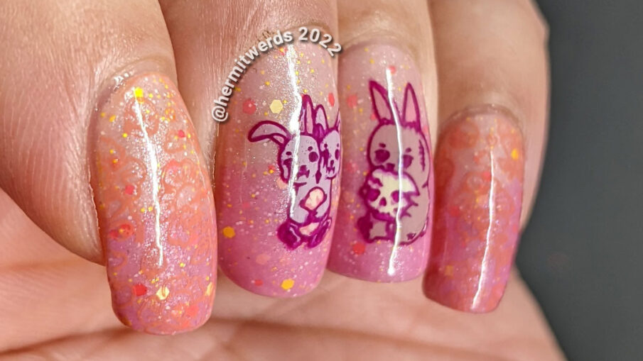 A holiday mashup nail design for Halloween and Easter with a pink/yellow thermal polish and zombie/monster rabbit stamping decals.