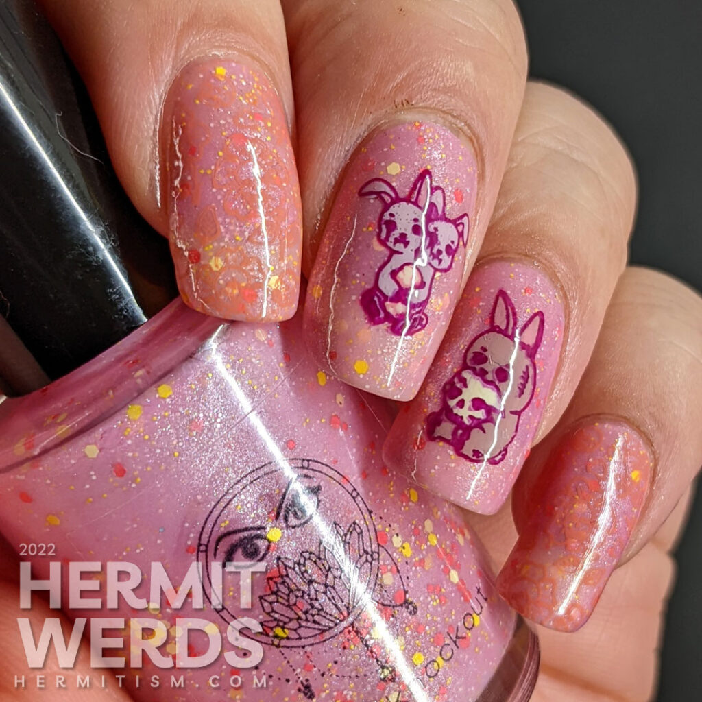 A holiday mashup nail design for Halloween and Easter with a pink/yellow thermal polish and zombie/monster rabbit stamping decals.