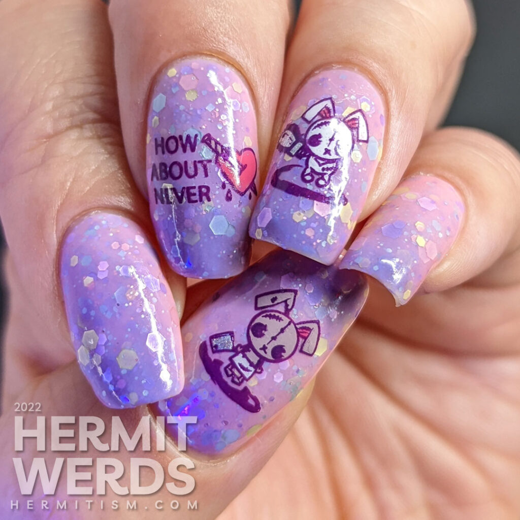 An anti-Valentine/Easter/Halloween pink/purple solar crelly mani with emo bunny stamping decals wielding indifference and a chainsaw/knife.