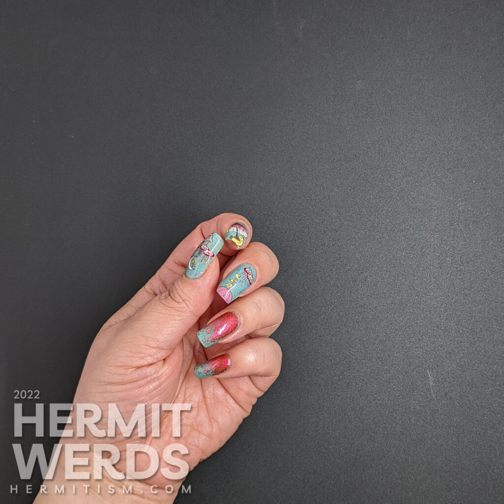 A blue and red nail art with stamping decals of pink umbrellas, singing yellow birds, and rainy clouds and two nails covered in red flakies.