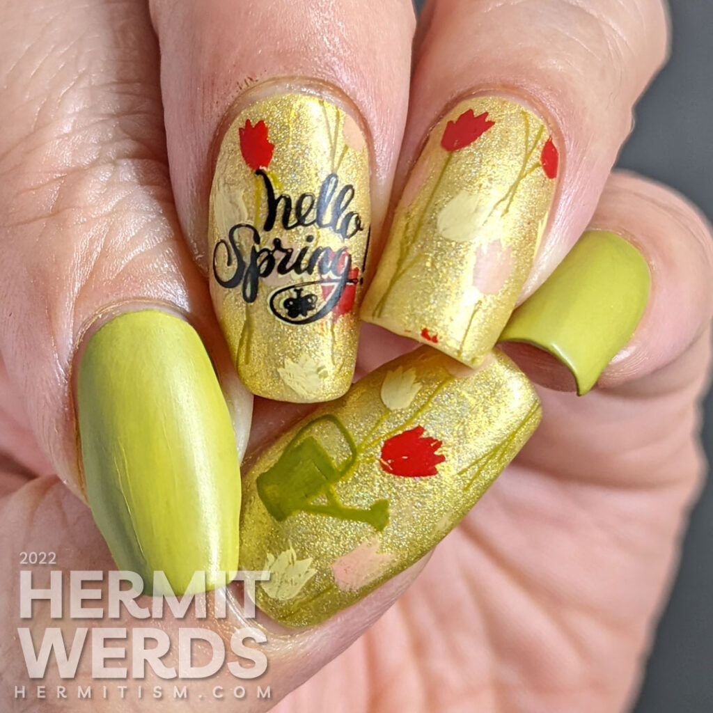 A spring floral mani with yellow, red, and pink tulips and a watering can stamped over a bright green holographic polish.