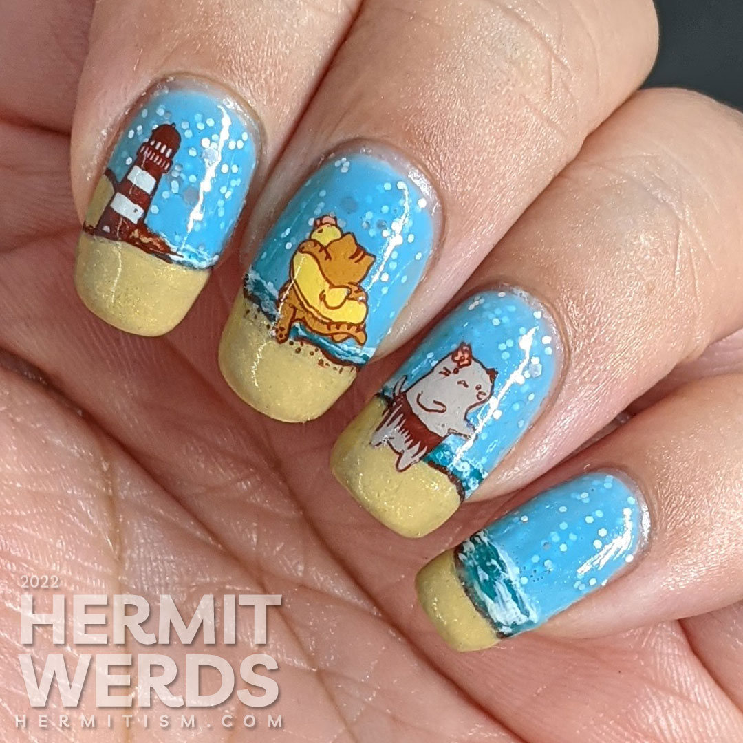 Beach kitty nail art with stamping decals of cute cats playing on a sandy beach and catching some rays. Plus a bonus lighthouse.