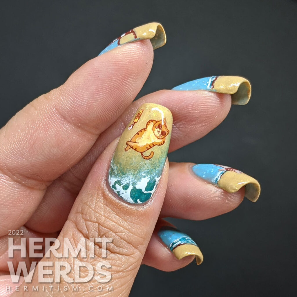 Beach kitty nail art with stamping decals of cute cats playing on a sandy beach and catching some rays. Plus a bonus lighthouse.