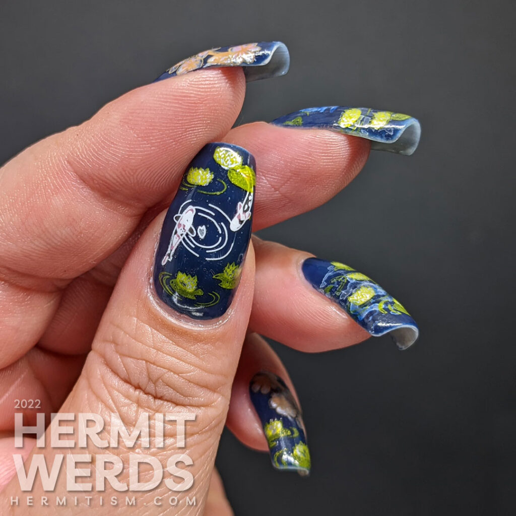 A smoky blue lily pond mani with the reflection of the flower moon shining forth, spring cherry blossom stamping decals, and koi.