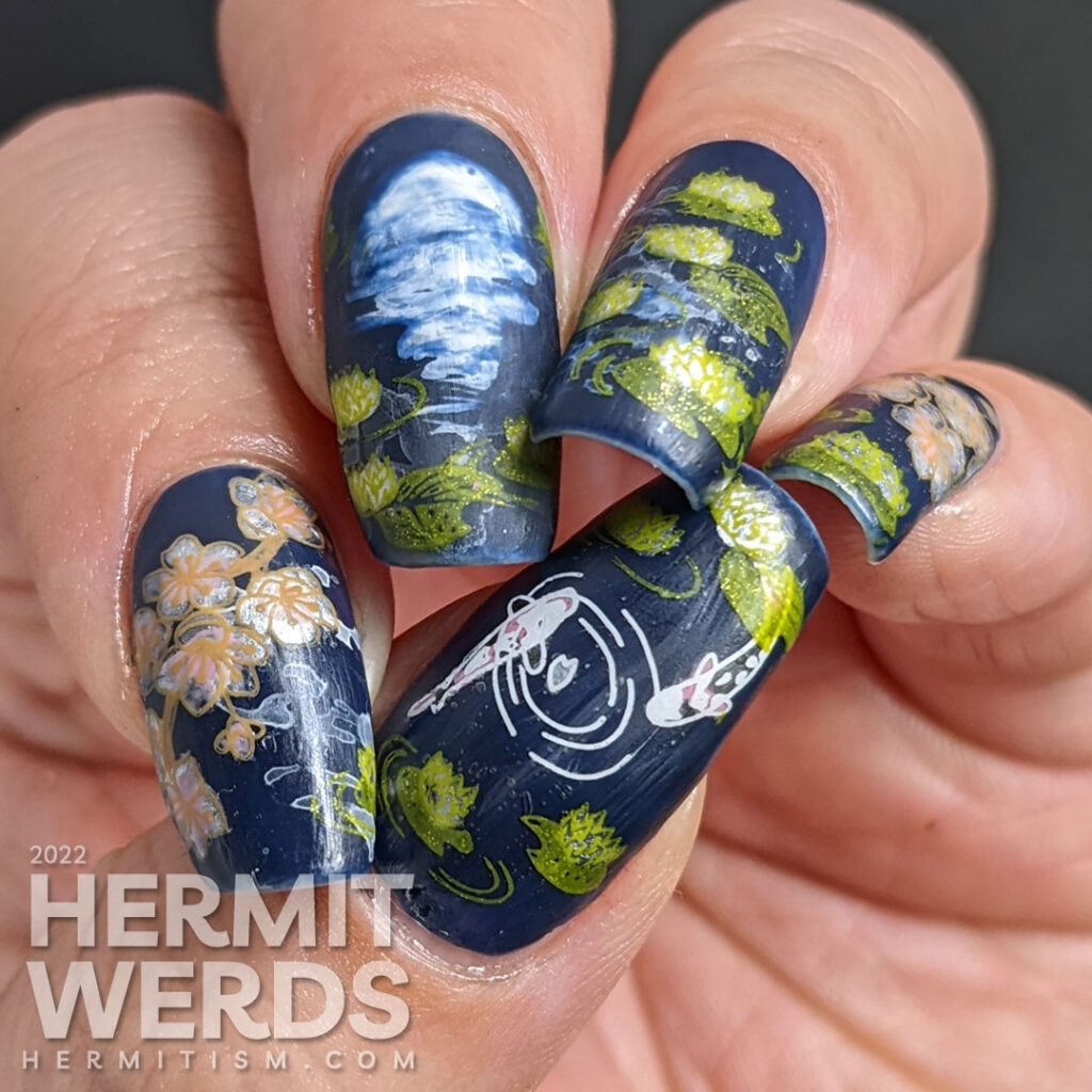 A smoky blue lily pond mani with the reflection of the flower moon shining forth, spring cherry blossom stamping decals, and koi.