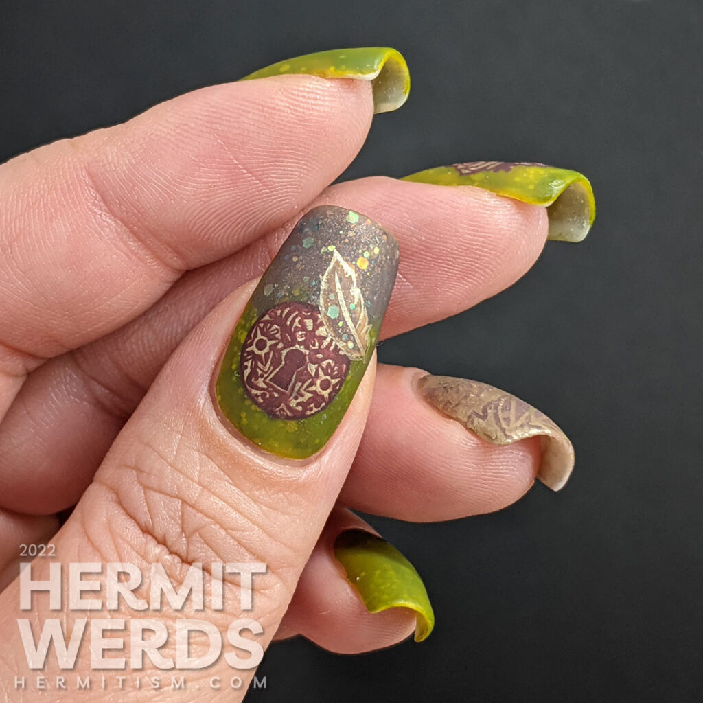A cedar green owl nail art with an iridescent glitter jelly sandwich and owl, feathers, lock, and key reverse stamping decals.