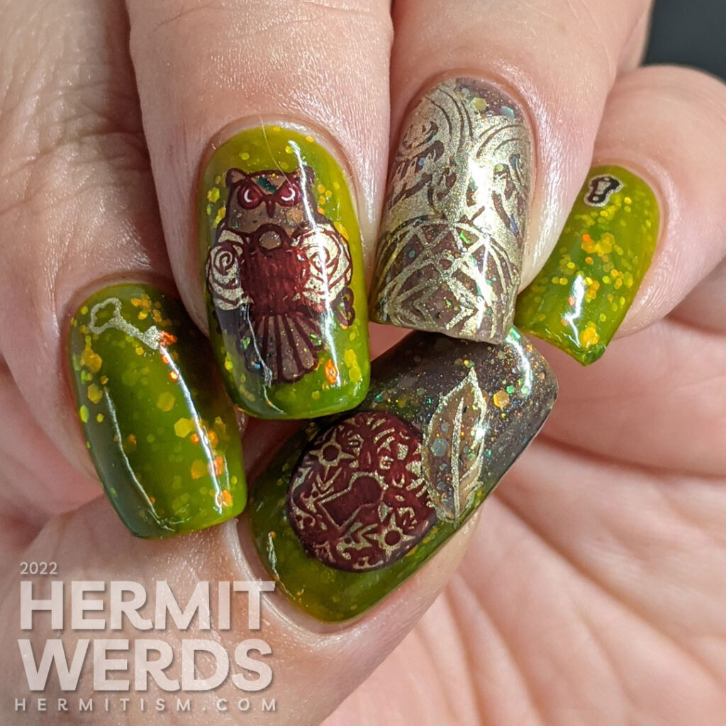 A cedar green owl nail art with an iridescent glitter jelly sandwich and owl, feathers, lock, and key reverse stamping decals.