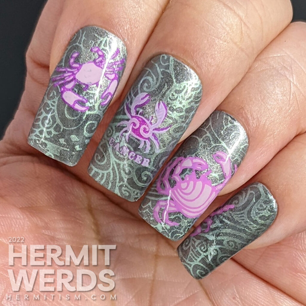 A sterling silver magnetic (zodiac) cancer nail art w/reverse stamping decals of crabs and a swirly ocean/shell background pattern.