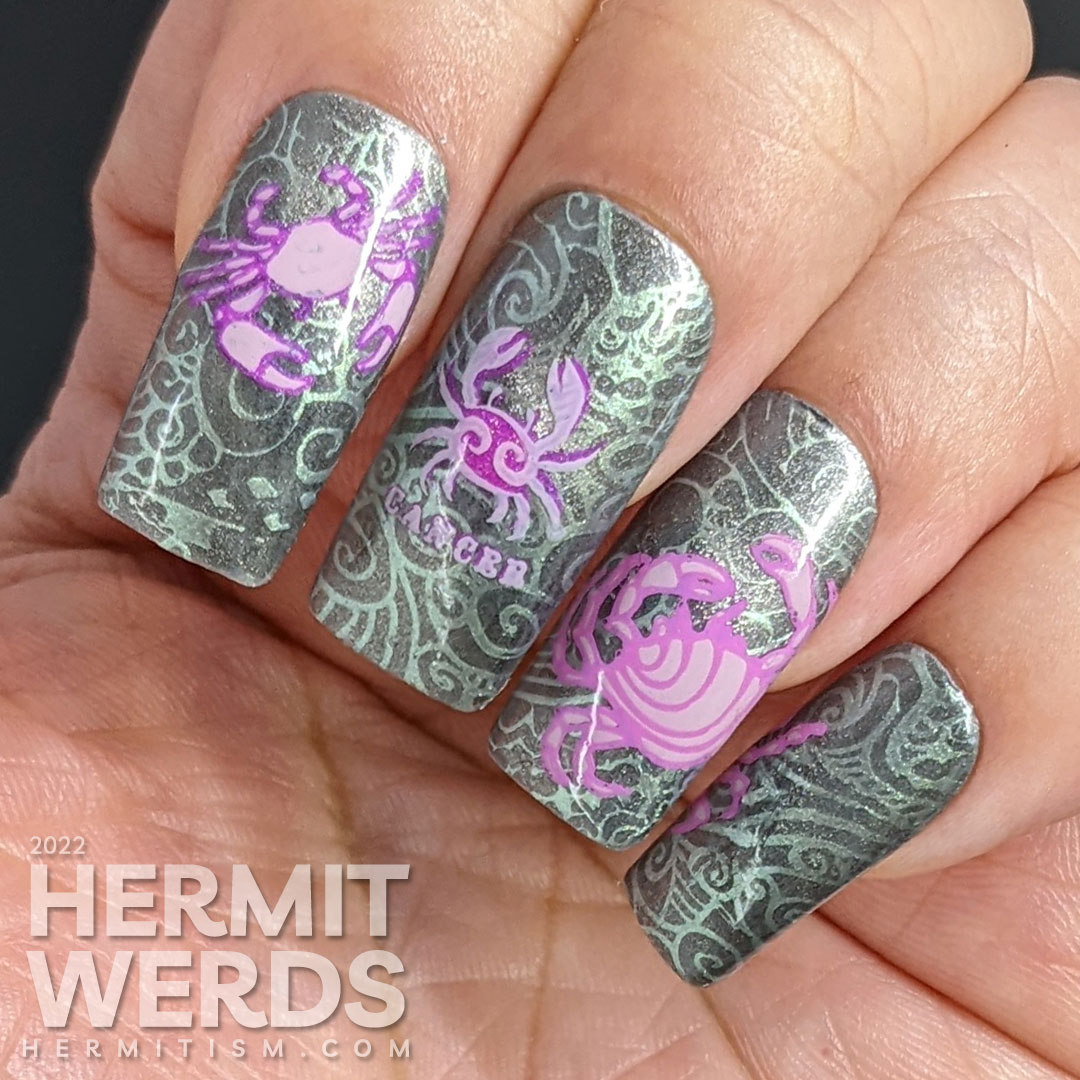 A sterling silver magnetic (zodiac) cancer nail art w/reverse stamping decals of crabs and a swirly ocean/shell background pattern.