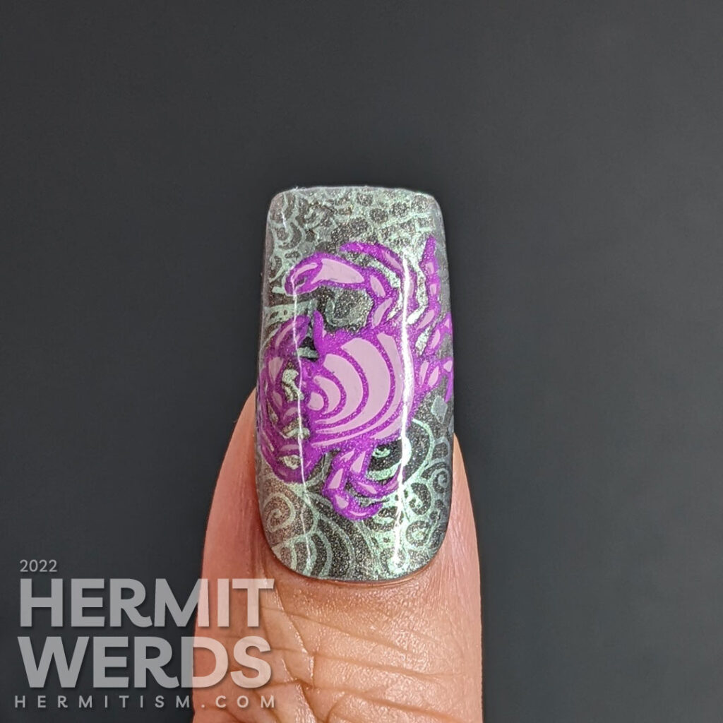 A sterling silver magnetic (zodiac) cancer nail art w/reverse stamping decals of crabs and a swirly ocean/shell background pattern.