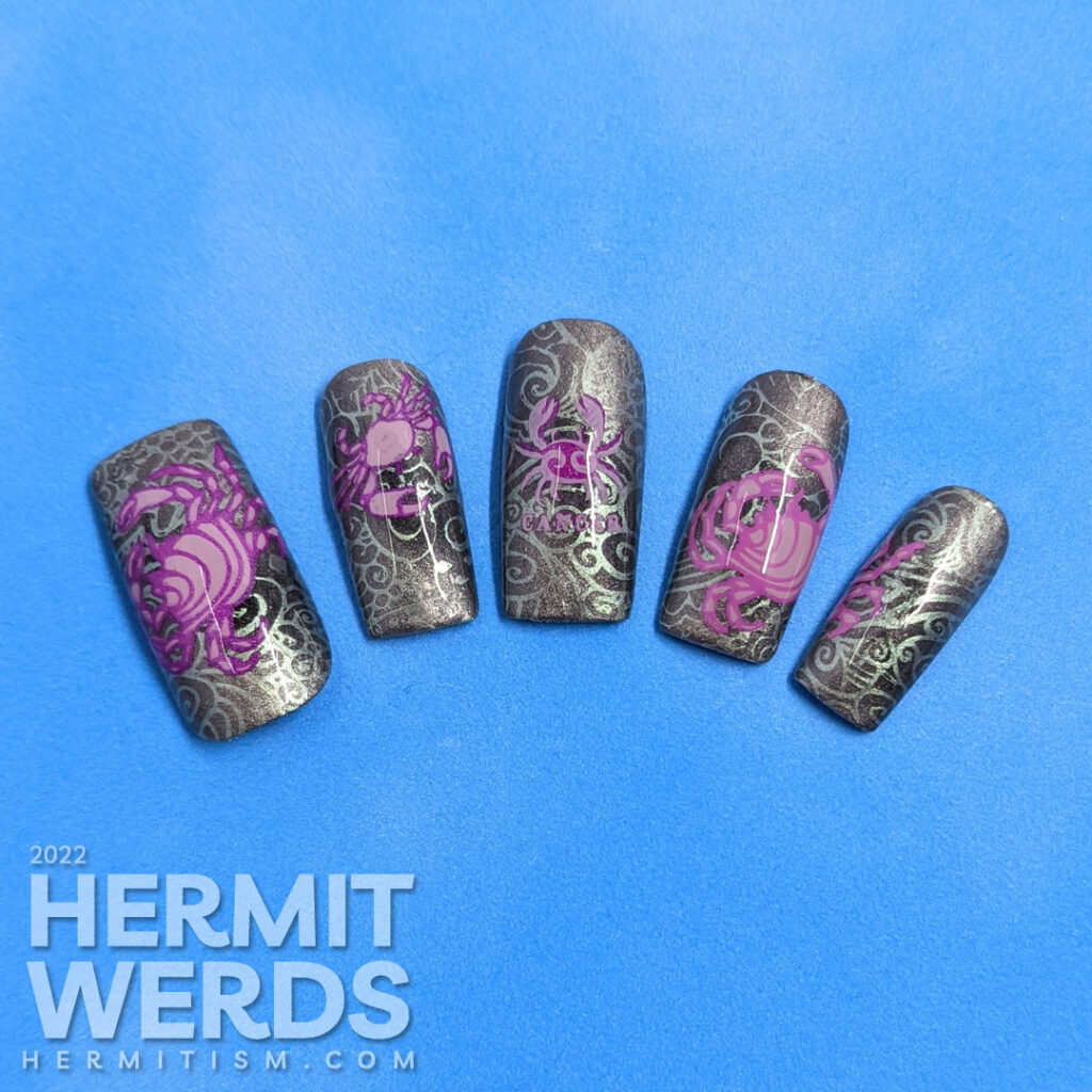 A sterling silver magnetic (zodiac) cancer nail art w/reverse stamping decals of crabs and a swirly ocean/shell background pattern.