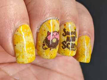 A devilish junk food nail art with stamping decals of a devil donut and "eye" scream, which were also stamped onto the yellow background.