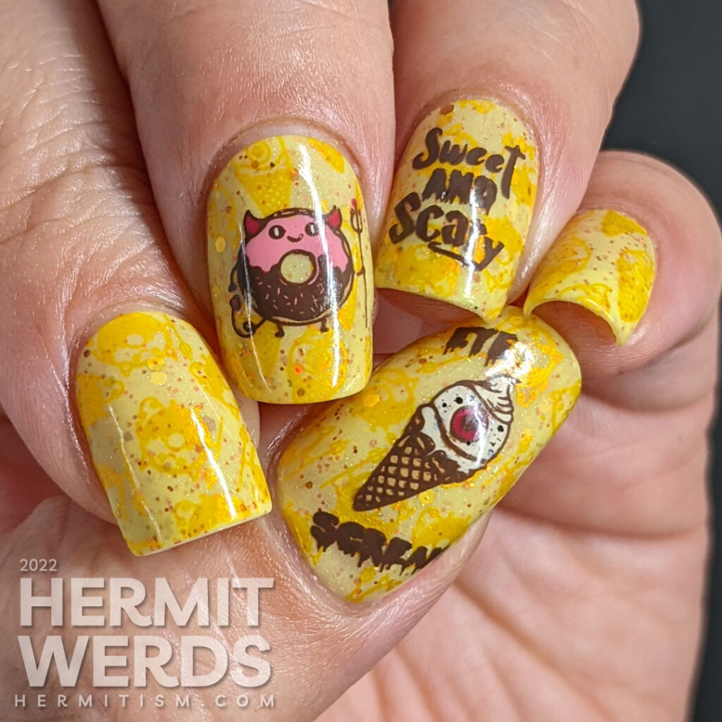 A devilish junk food nail art with stamping decals of a devil donut and "eye" scream, which were also stamped onto the yellow background.