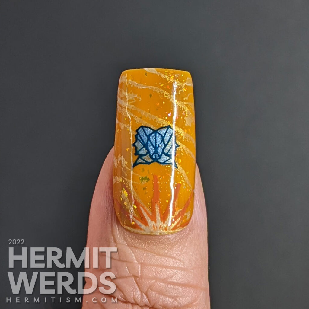 A warm mustard Gemini zodiac nail art with a pair of blue twin stamping decals, Gemini symbols, and a soft windy background stamp.