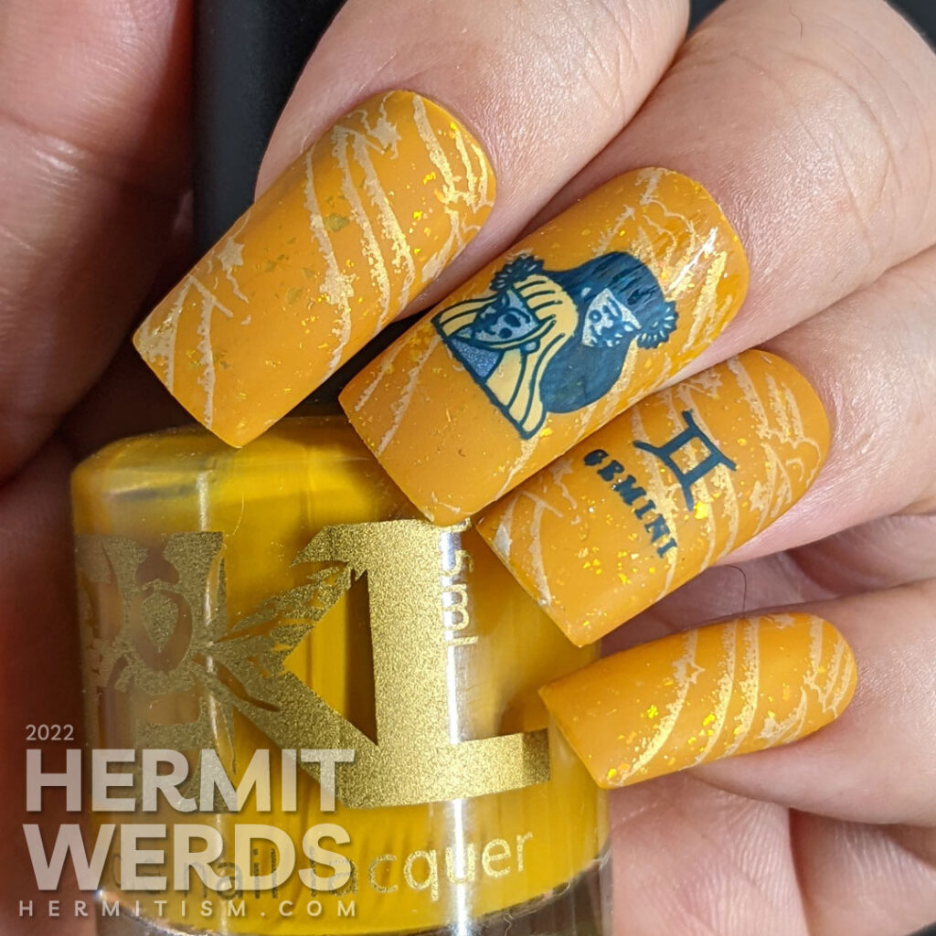 A warm mustard Gemini zodiac nail art with a pair of blue twin stamping decals, Gemini symbols, and a soft windy background stamp.