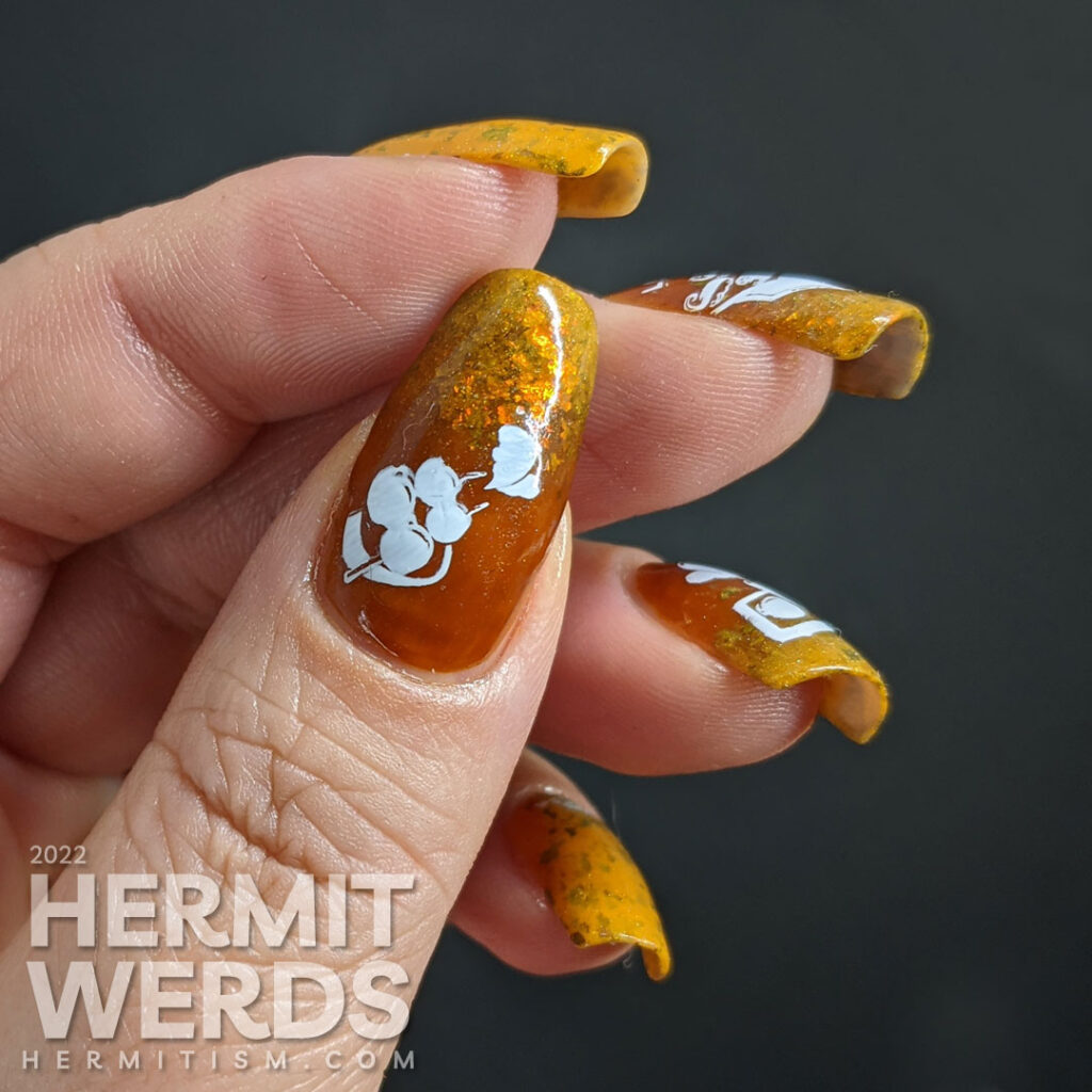 A simple mustard and turmeric sushi nail art with stamping images of a tray of sushi, nigiri, and a few other Japanese treats.