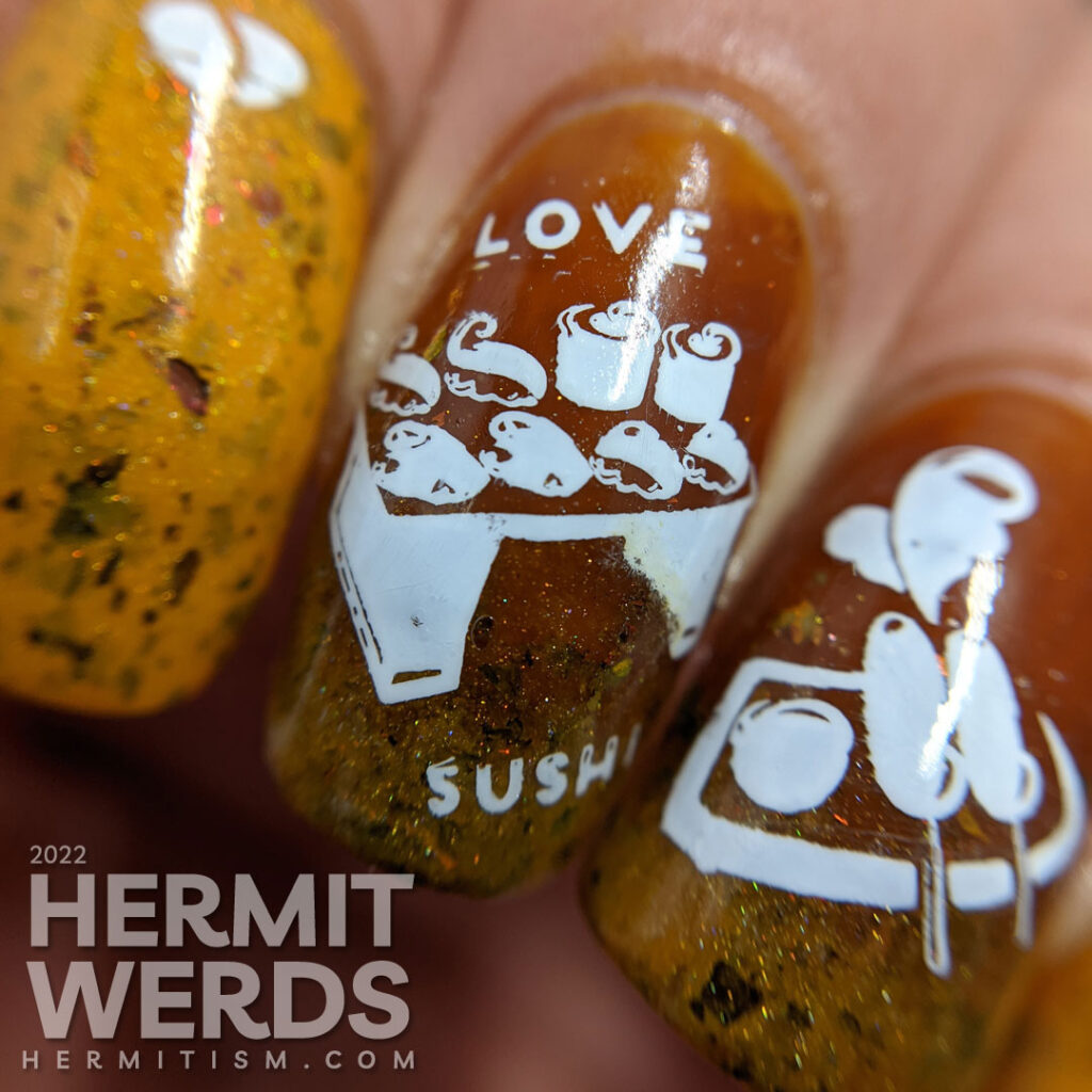 A simple mustard and turmeric sushi nail art with stamping images of a tray of sushi, nigiri, and a few other Japanese treats.