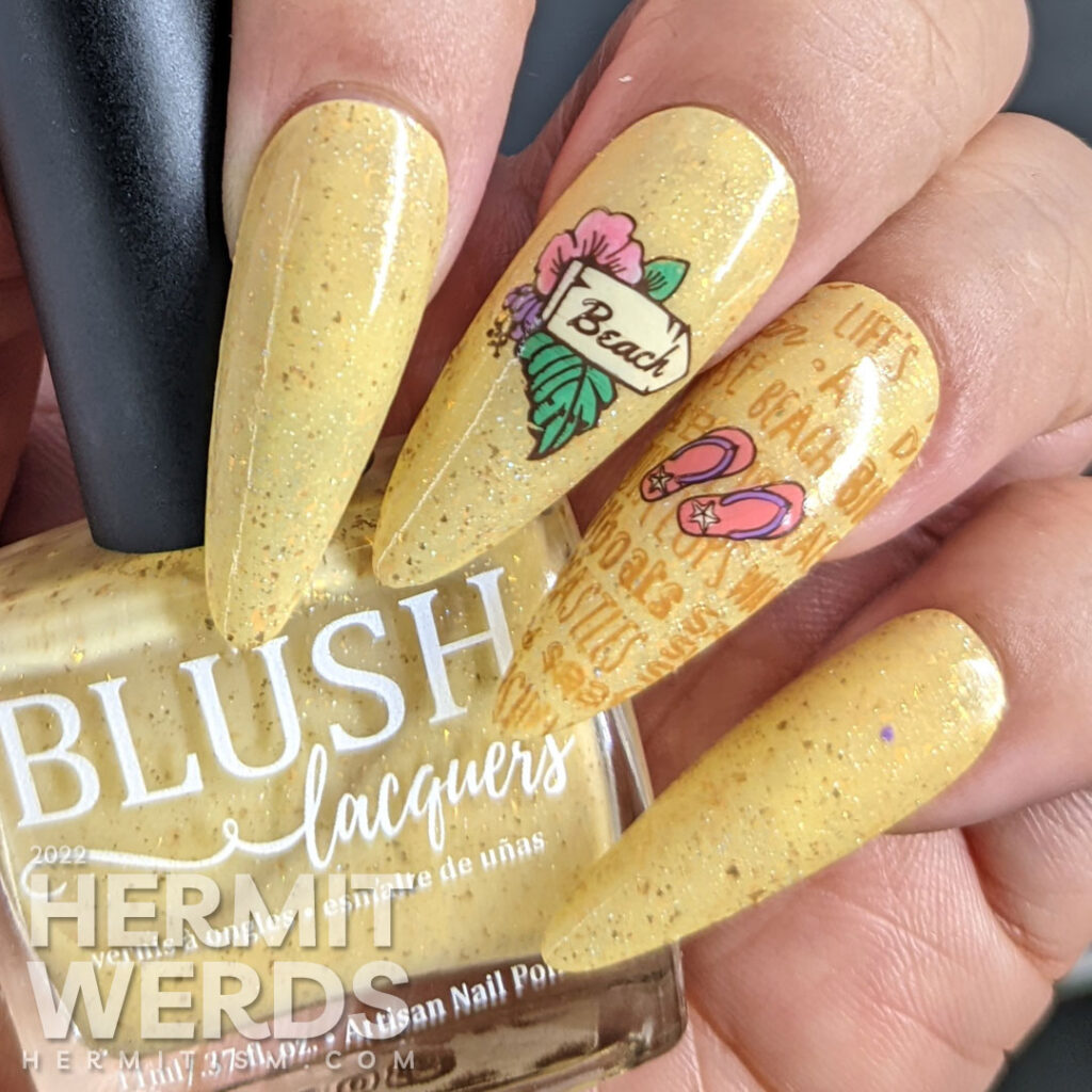 A sandy, beachy nail art with a sign pointing towards the beach, flip flops, and a bag of beach-going essentials plus beach-y words.