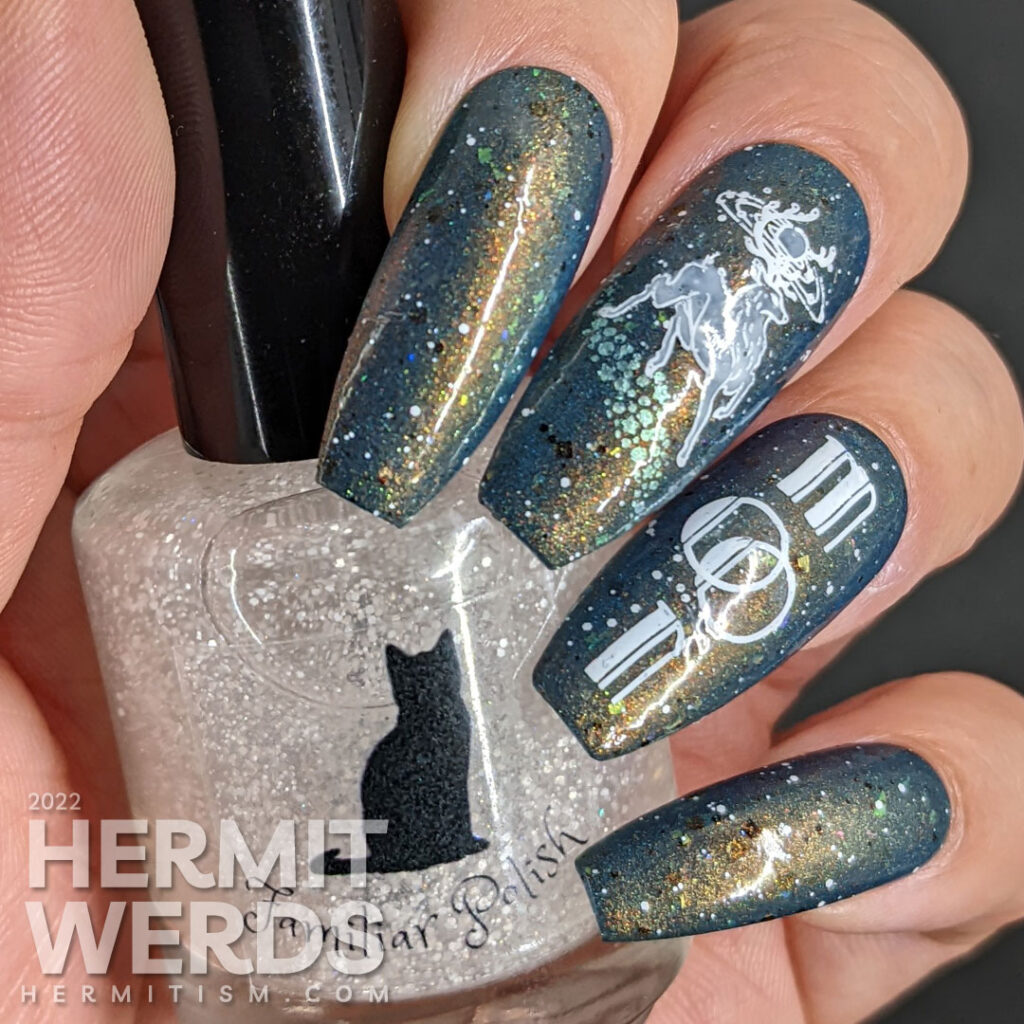 A deep blue and shimmery galaxy nail art celebrating the full buck moon with stamping decals of astral bucks leaping amongst the stars.