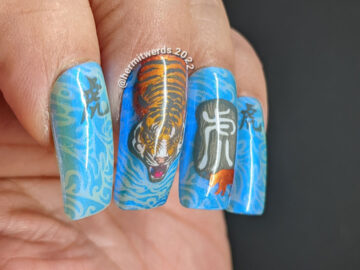 Chinese New Year of the Tiger nail art in their lucky colors (blue, grey, white, orange) w/nail stamping decals of tigers & Chinese characters.