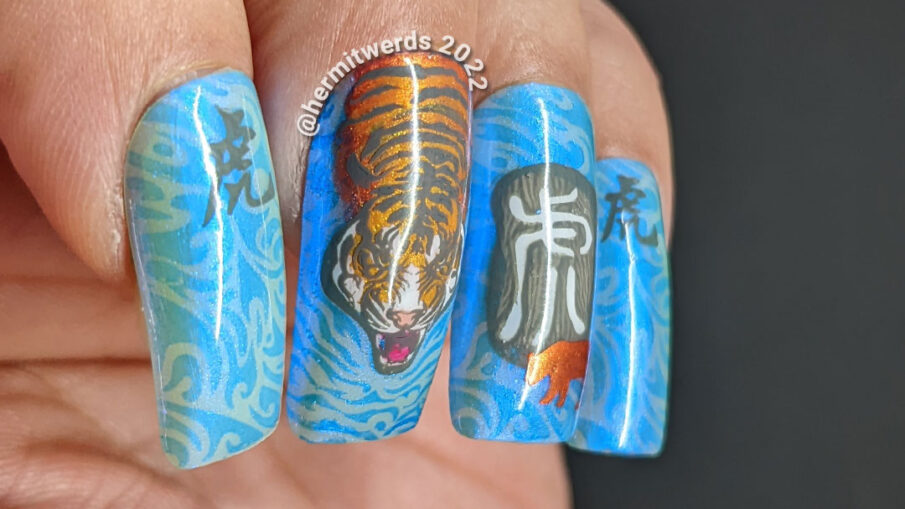 Chinese New Year of the Tiger nail art in their lucky colors (blue, grey, white, orange) w/nail stamping decals of tigers & Chinese characters.